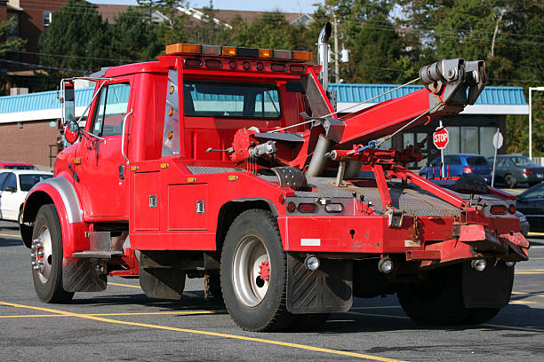 Red tow truck in a mall parking lot